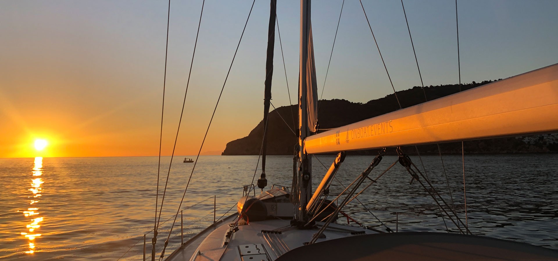 Sunset aboard SY HERA with a calm cockpit and sea view